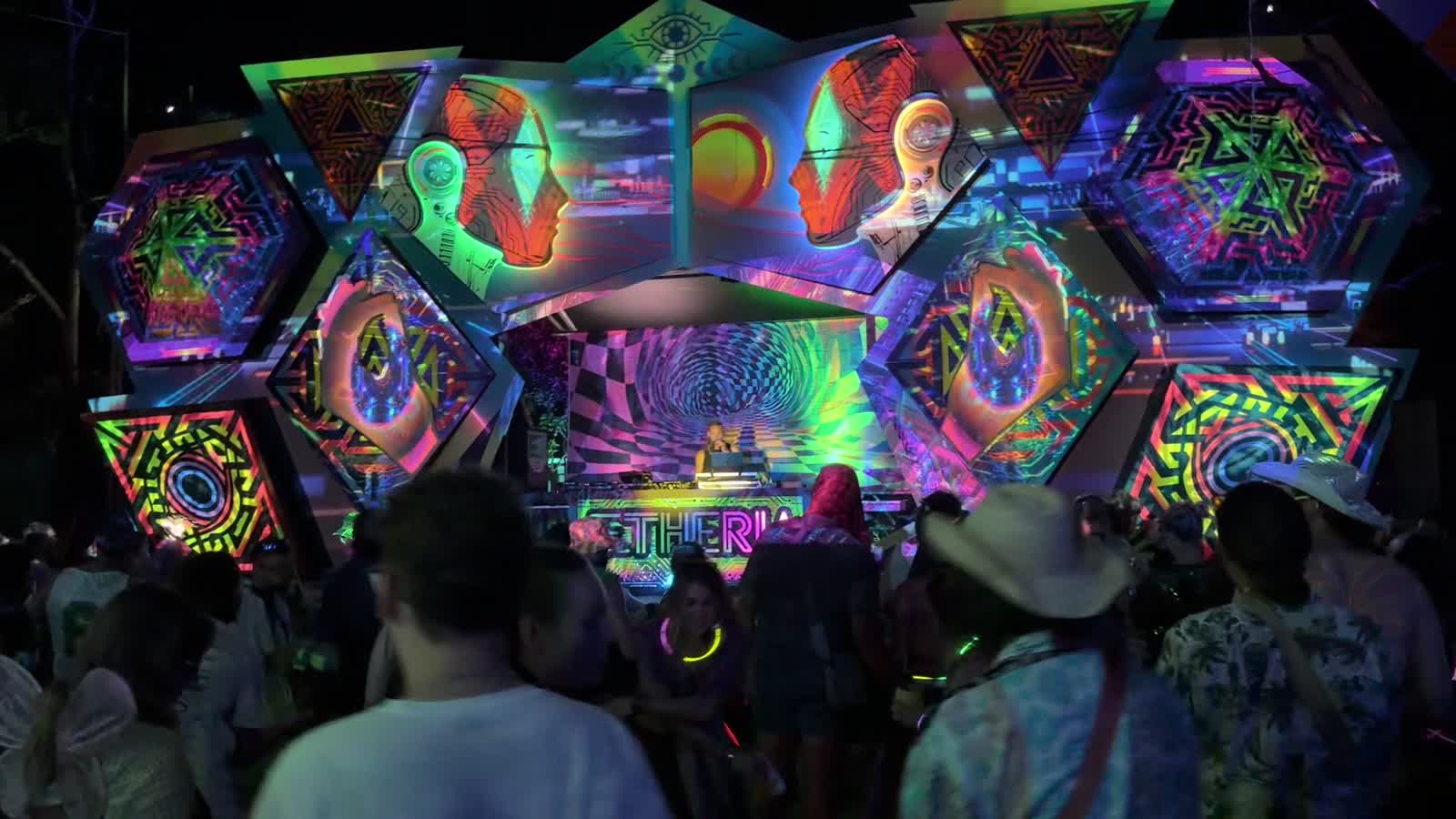 Golden light trails surrounding festivalgoers at Aetheria